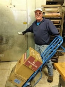 Dave Mortensen loads frozen raspberries into the walk in freezer. Photo credit: Marlee Riggin