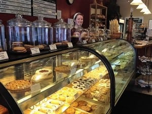 Dixie Pittman stands behind a full display case ready to serve lunch. Photo credit: Marlee Riggin