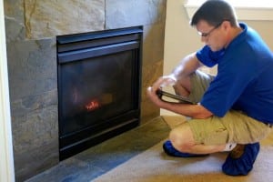 Keith Bowman inspects a fireplace in a new-construction home. Each Boggs Inspection Services inspector checks a new home from top to bottom in the same way they would an older home.