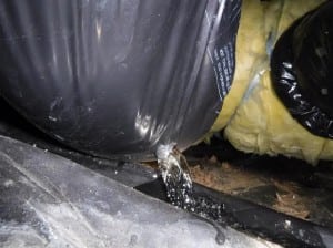 Water spills from inside a new construction home's ductwork from a hidden plumbing leak discovered during a Boggs home inspection.