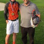 Noah with medal and coach